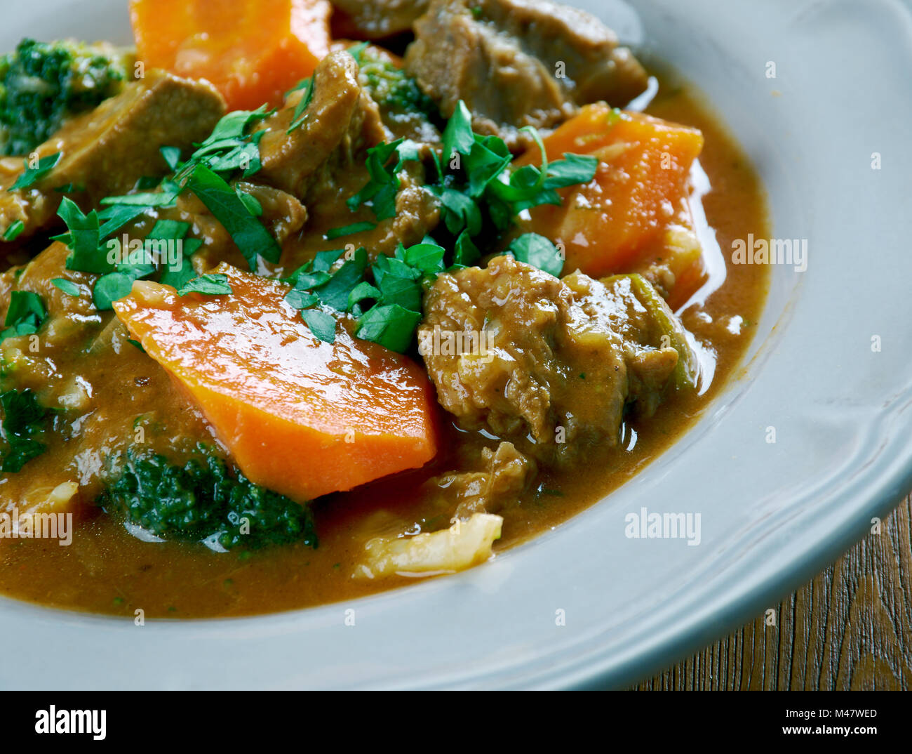 German traditional beef stew with carrots, dark beer Stock Photo Alamy