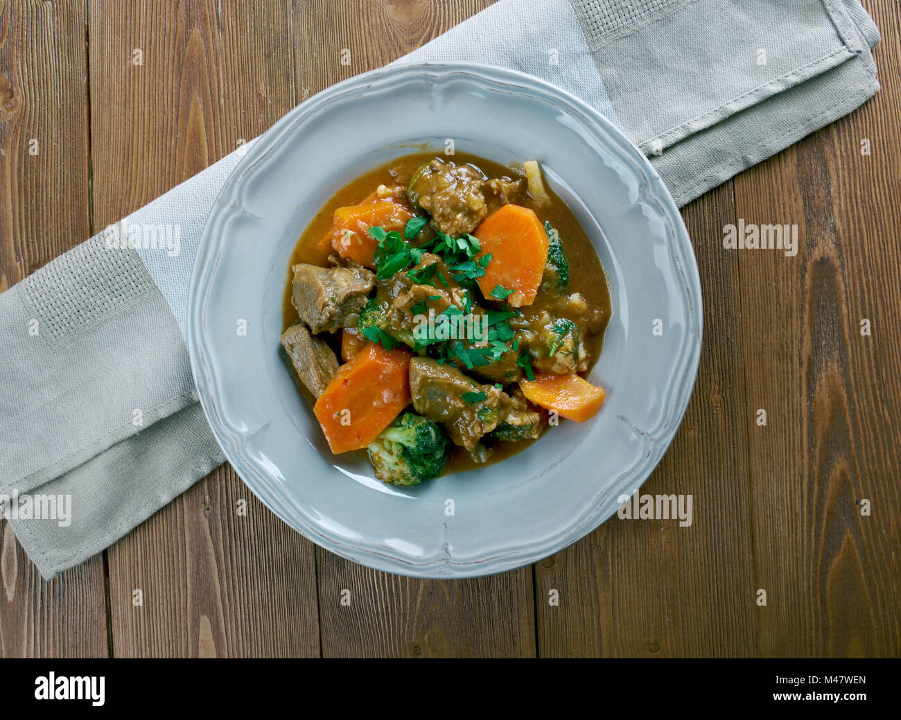 German traditional beef stew with carrots, dark beer Stock Photo Alamy
