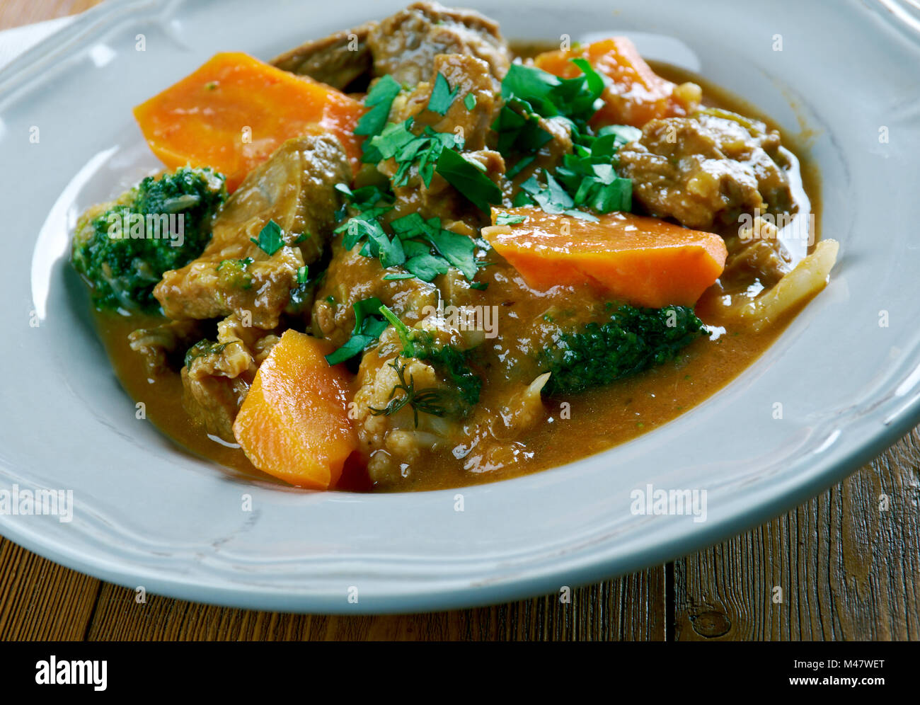German traditional beef stew with carrots, dark beer Stock Photo Alamy
