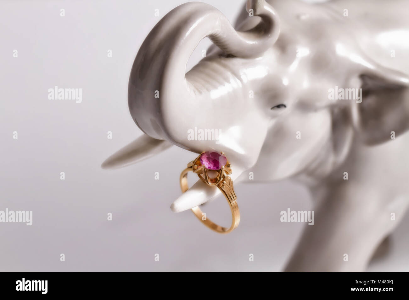 Porcelain figurine of an elephant with a silver ring Stock Photo
