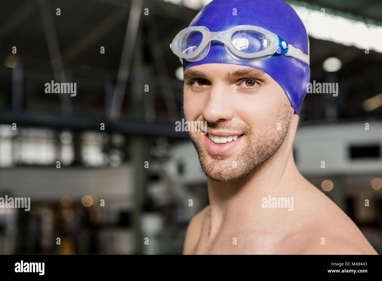 Portrait of swimmer wearing swimming goggles and cap Stock Photo