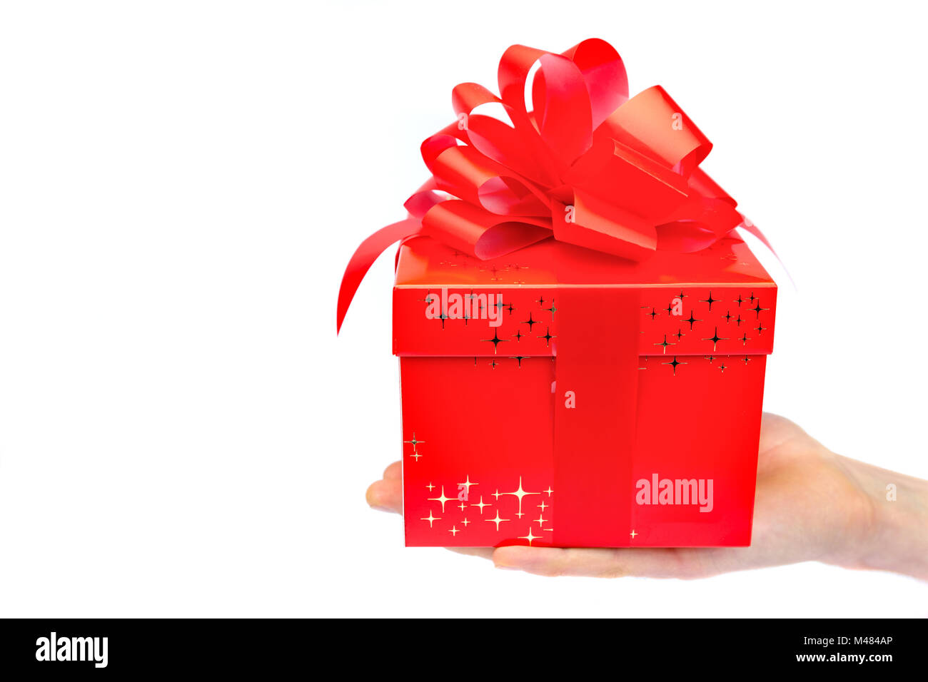 Male hand presenting red christmas box on flat hand Stock Photo