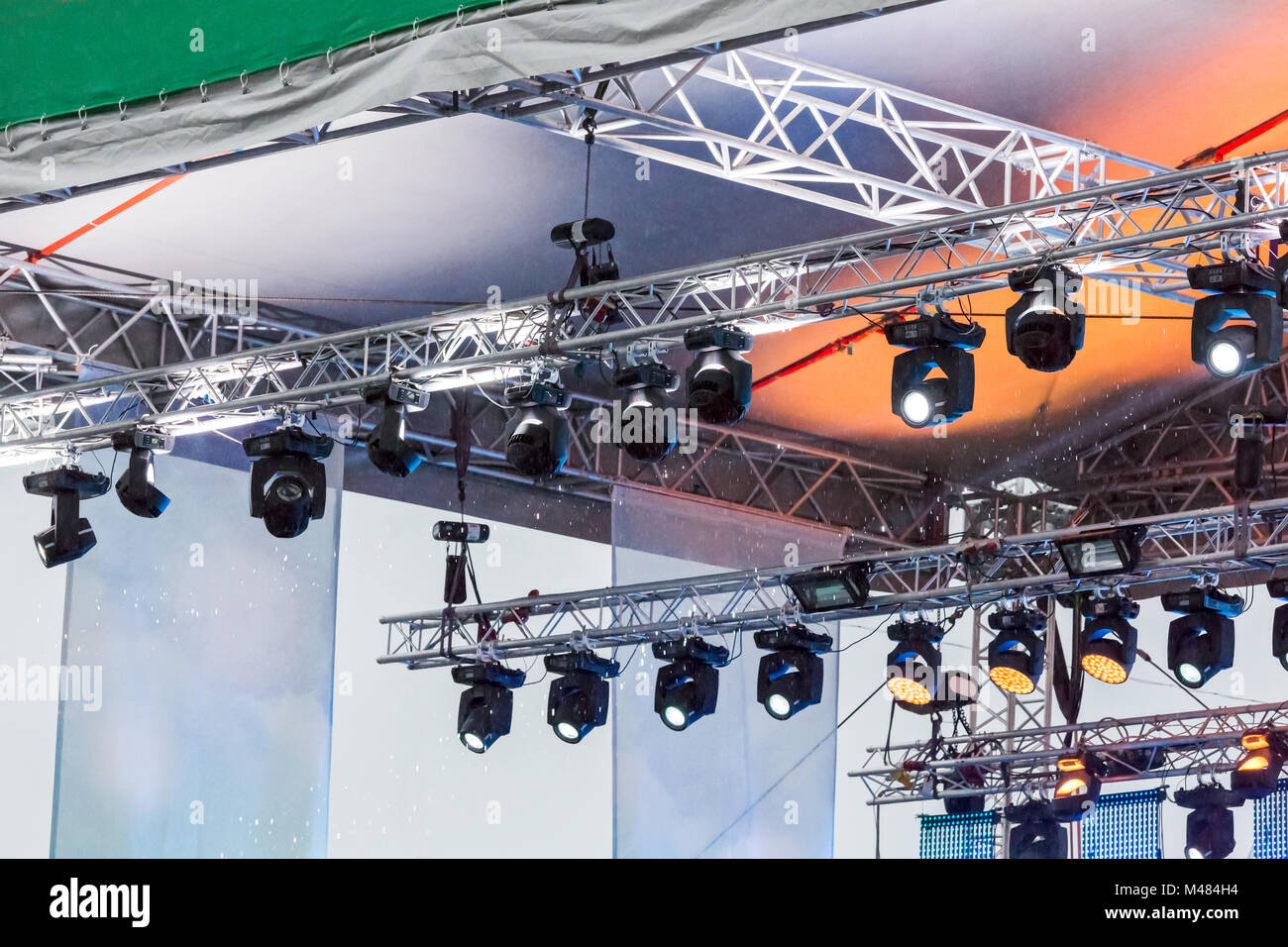 row of spotlights under roof of outdoor stage Stock Photo