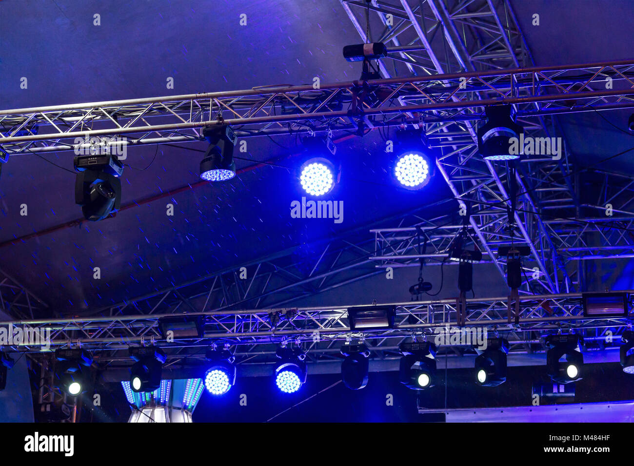 bright blue stage lights during the rain Stock Photo