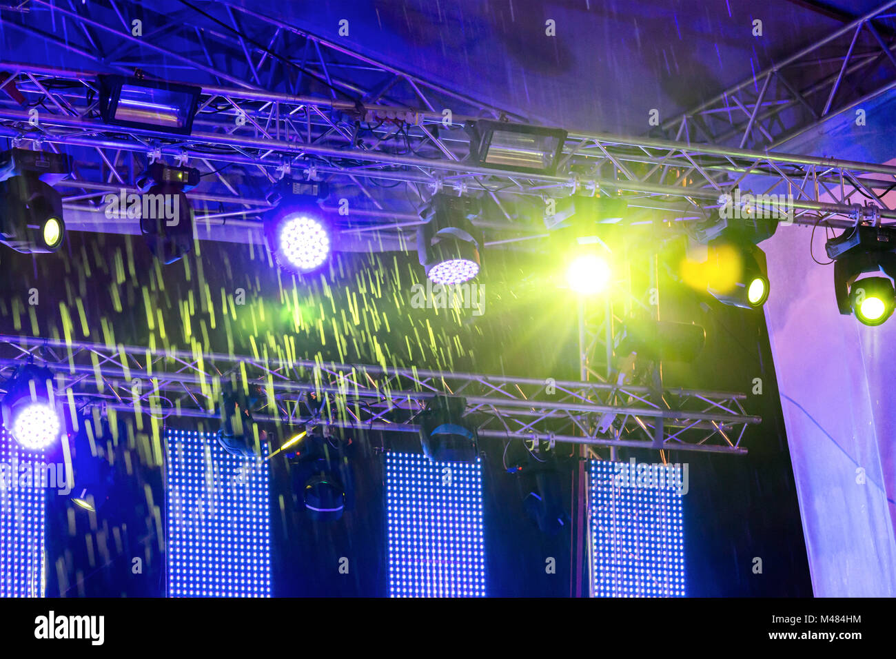 colorful stage light with raindrops at night Stock Photo