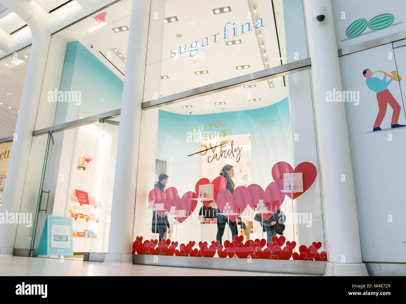 New York, Feb 9, 2018: Young man and woman are seen browsing a Sugarfina store. Stock Photo