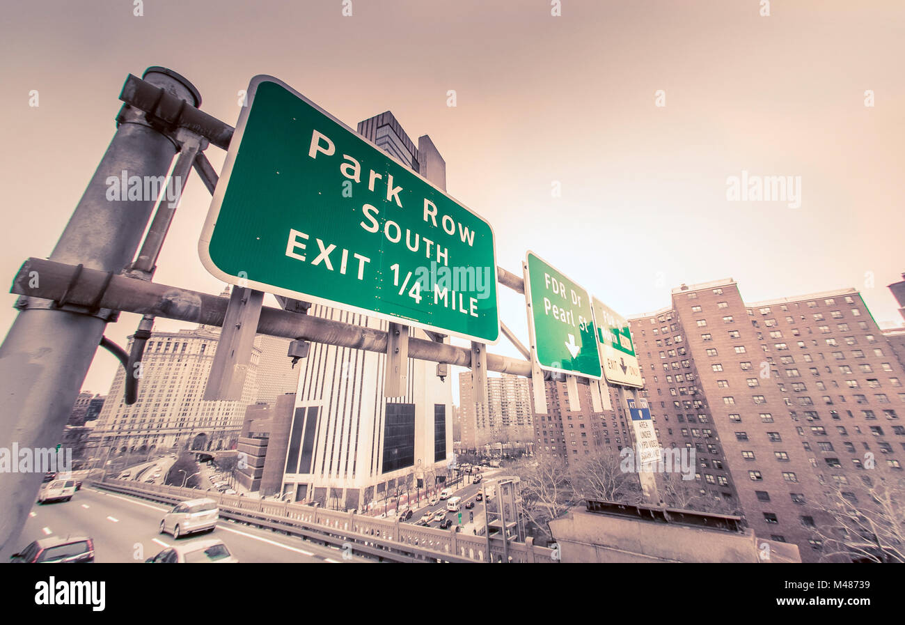 Road signs directing traffic exiting Brooklyn Bridge into Manhattan. Stock Photo