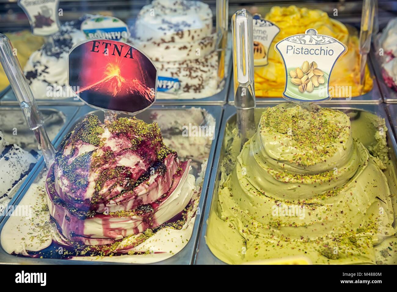 Variety of yummy ice creams under shopping window Stock Photo