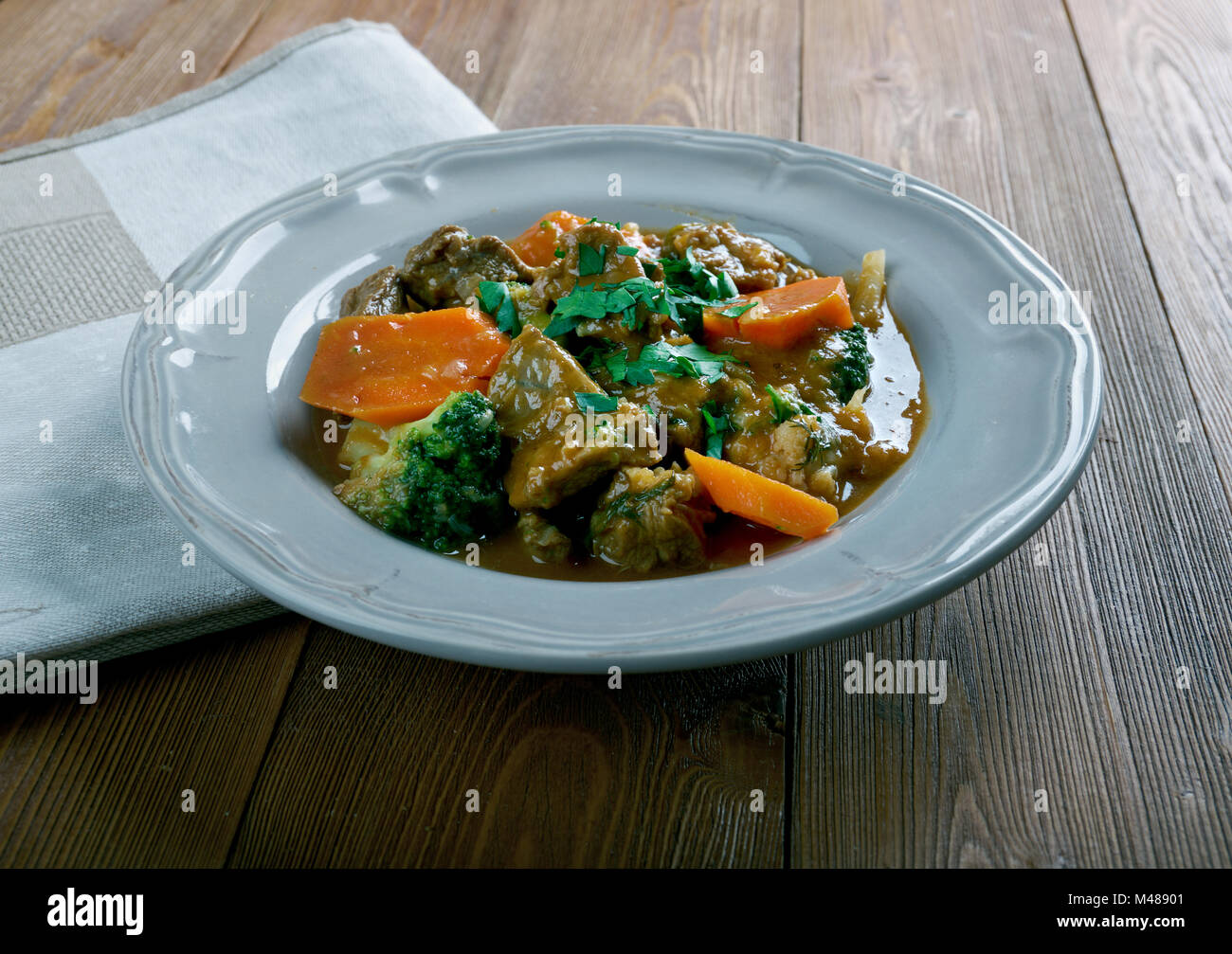 German traditional beef stew with carrots, dark beer Stock Photo Alamy