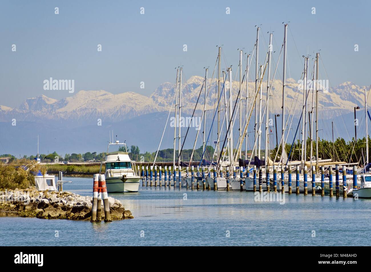 marina with sailing boats in front of the snow-covered alps Stock Photo