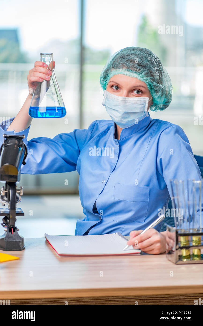 Experienced lab assistant working on chemical solutions Stock Photo - Alamy