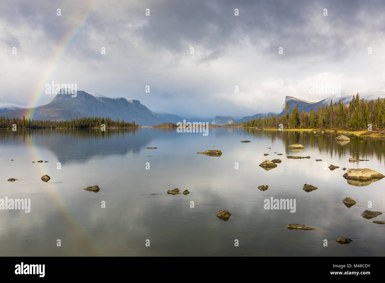 Rainbow reflecting in Lake Laitaure, Lapland, Sweden Stock Photo