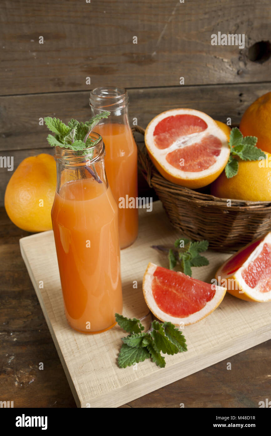Natural and fresh grapefruit juice in small bottles Stock Photo