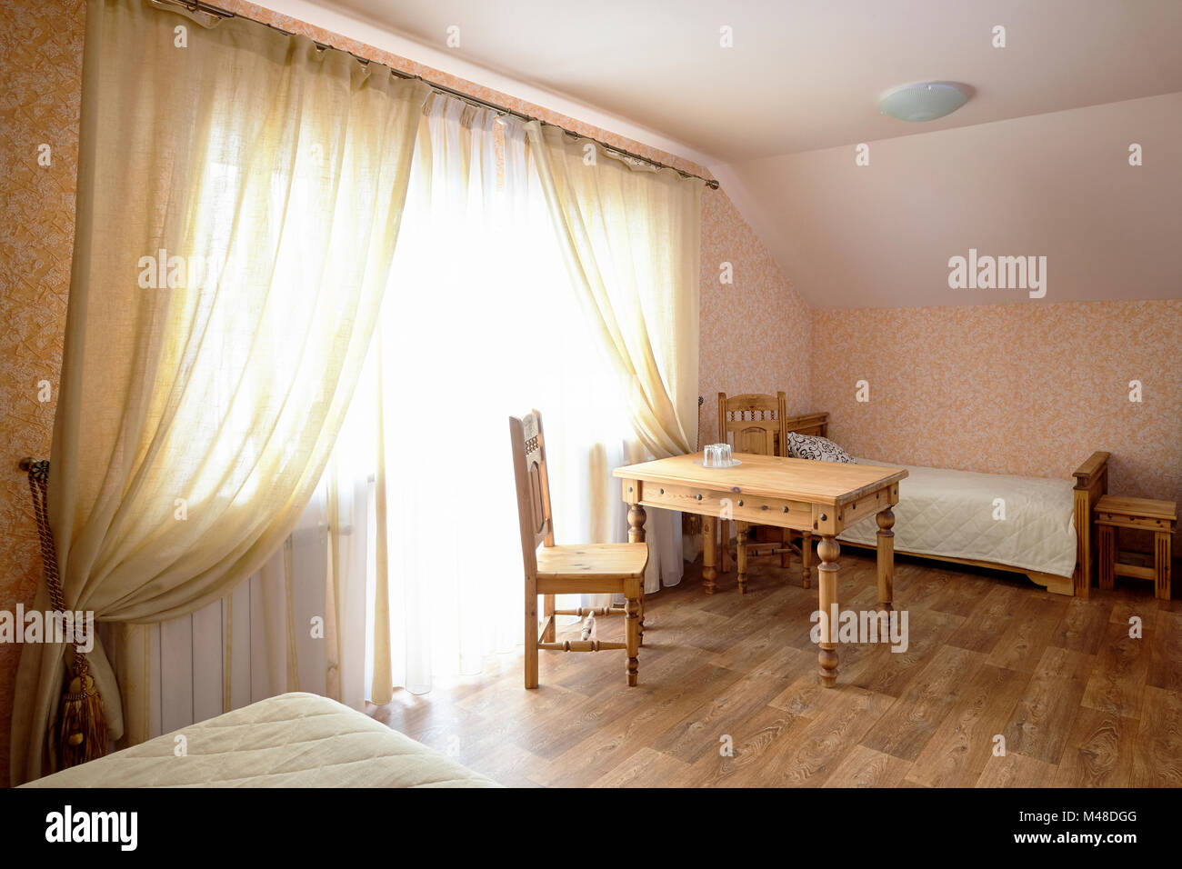 Rural Hostel Room Interior With Wooden Furniture Stock Photo