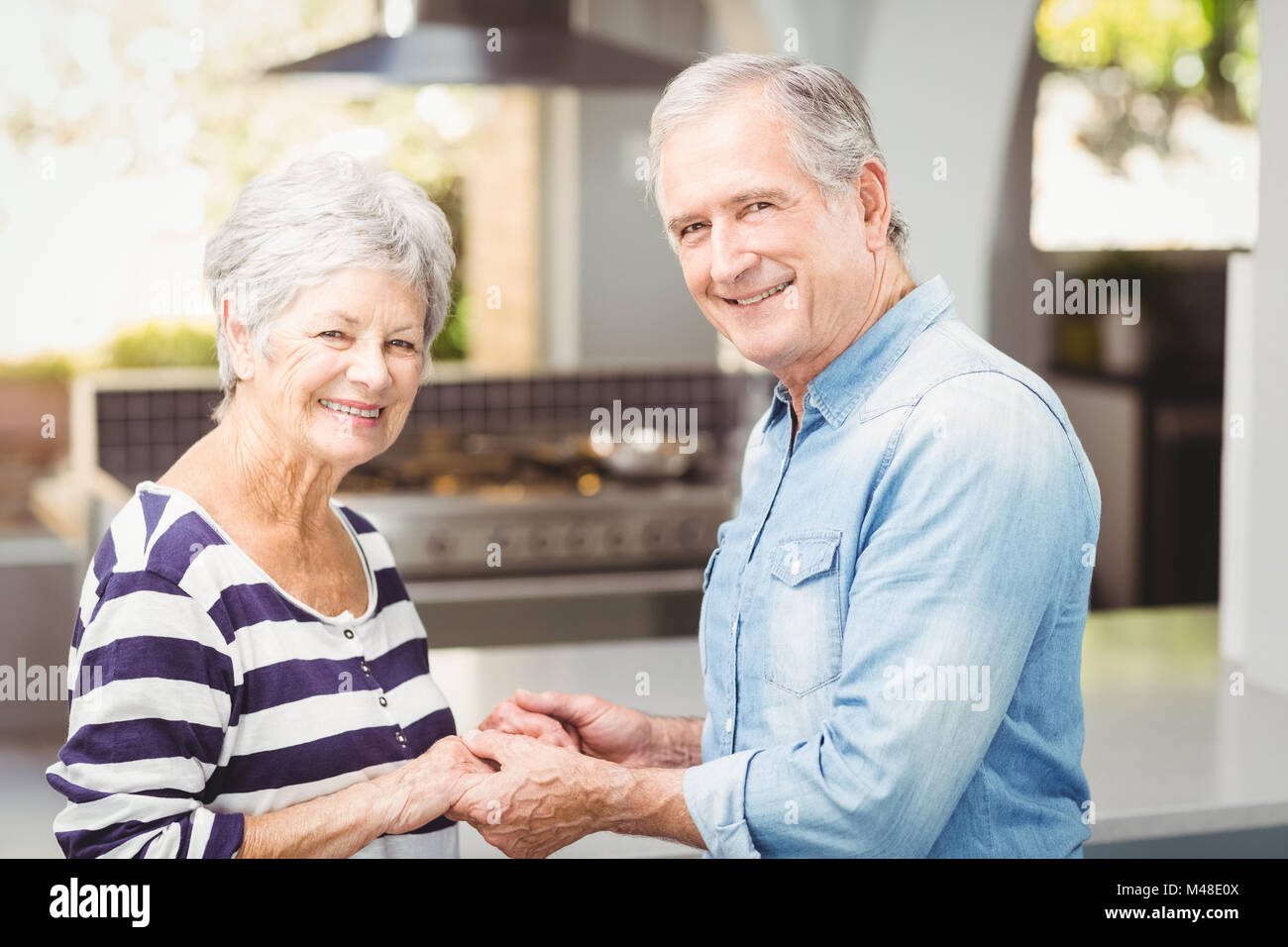 Portrait of happy senior couple holding hands Stock Photo - Alamy