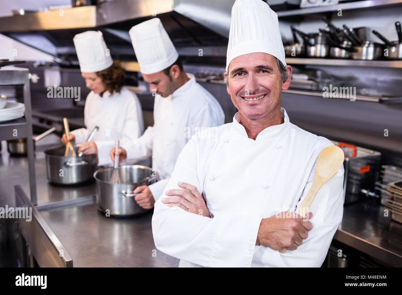 Portrait of smiling chef in commercial kitchen Stock Photo