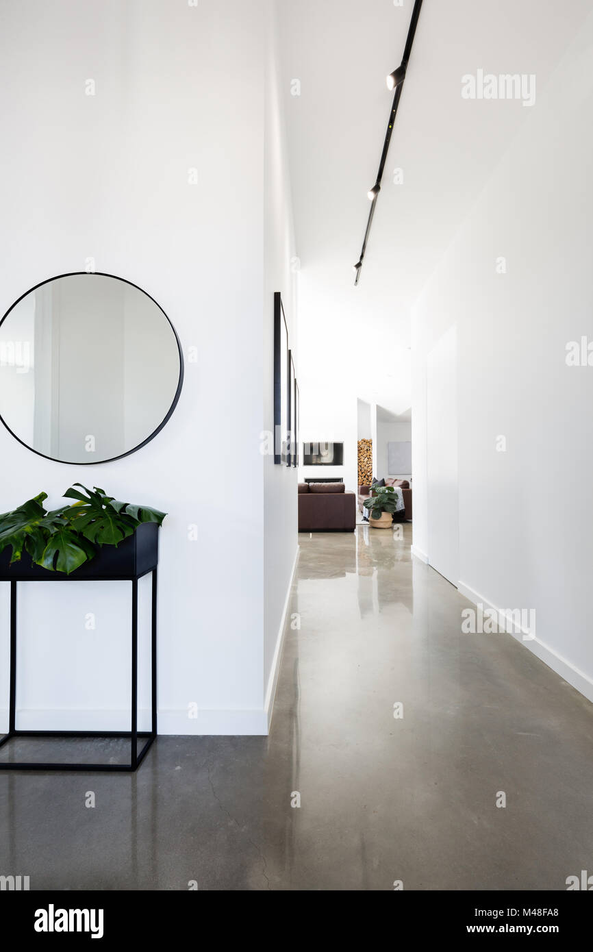 Contemporary new home entry and hallway with polished concrete floors Stock Photo