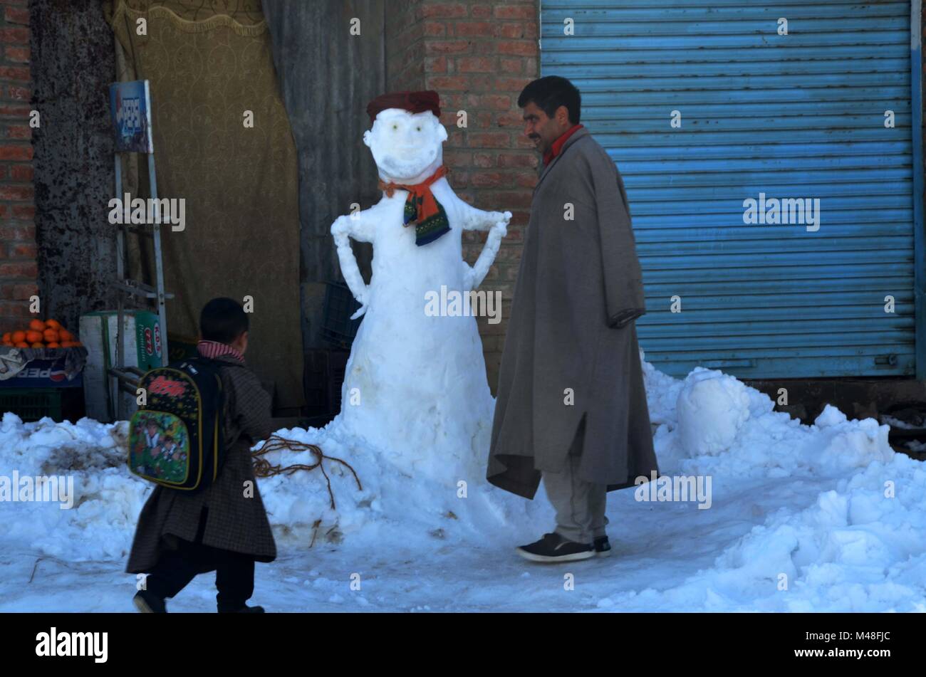 Gh Rasool Anantnag, India. 13th Feb, 2018. Gh Rasool and his son Emad walks past ...