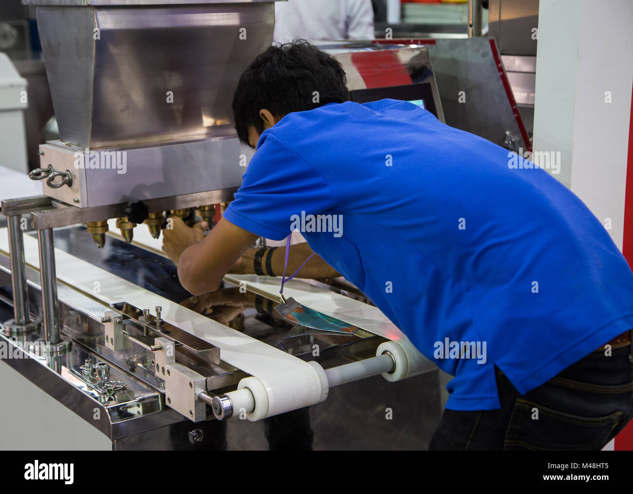 Food worker operate bakery making machine Stock Photo - Alamy
