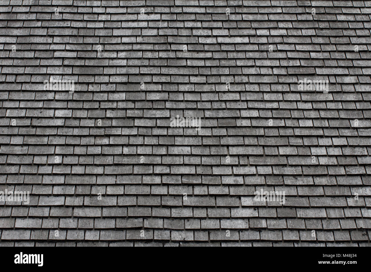 A grey slate roof background image Stock Photo - Alamy