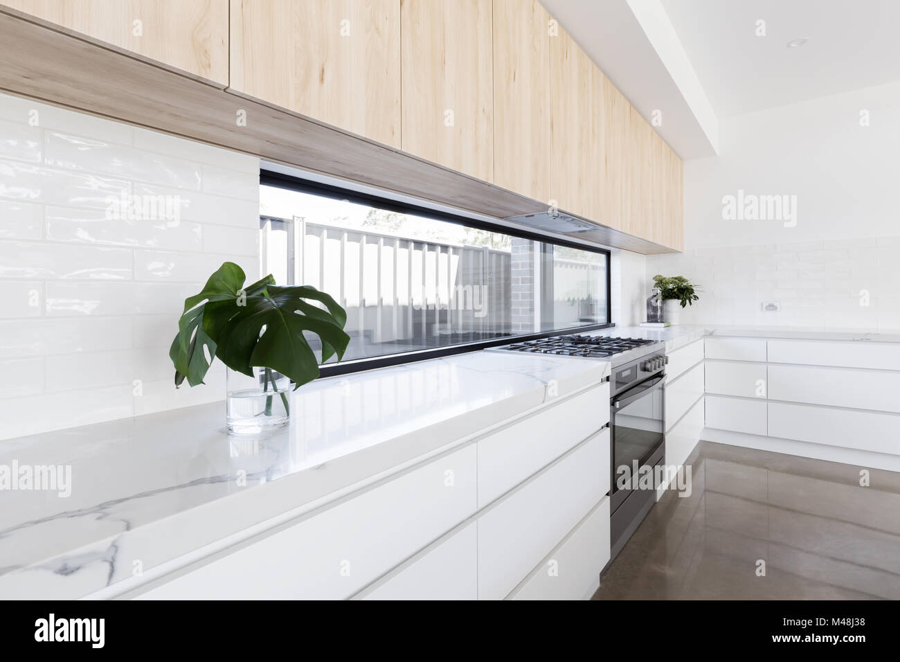 Modern luxury kitchen with window splashback Stock Photo