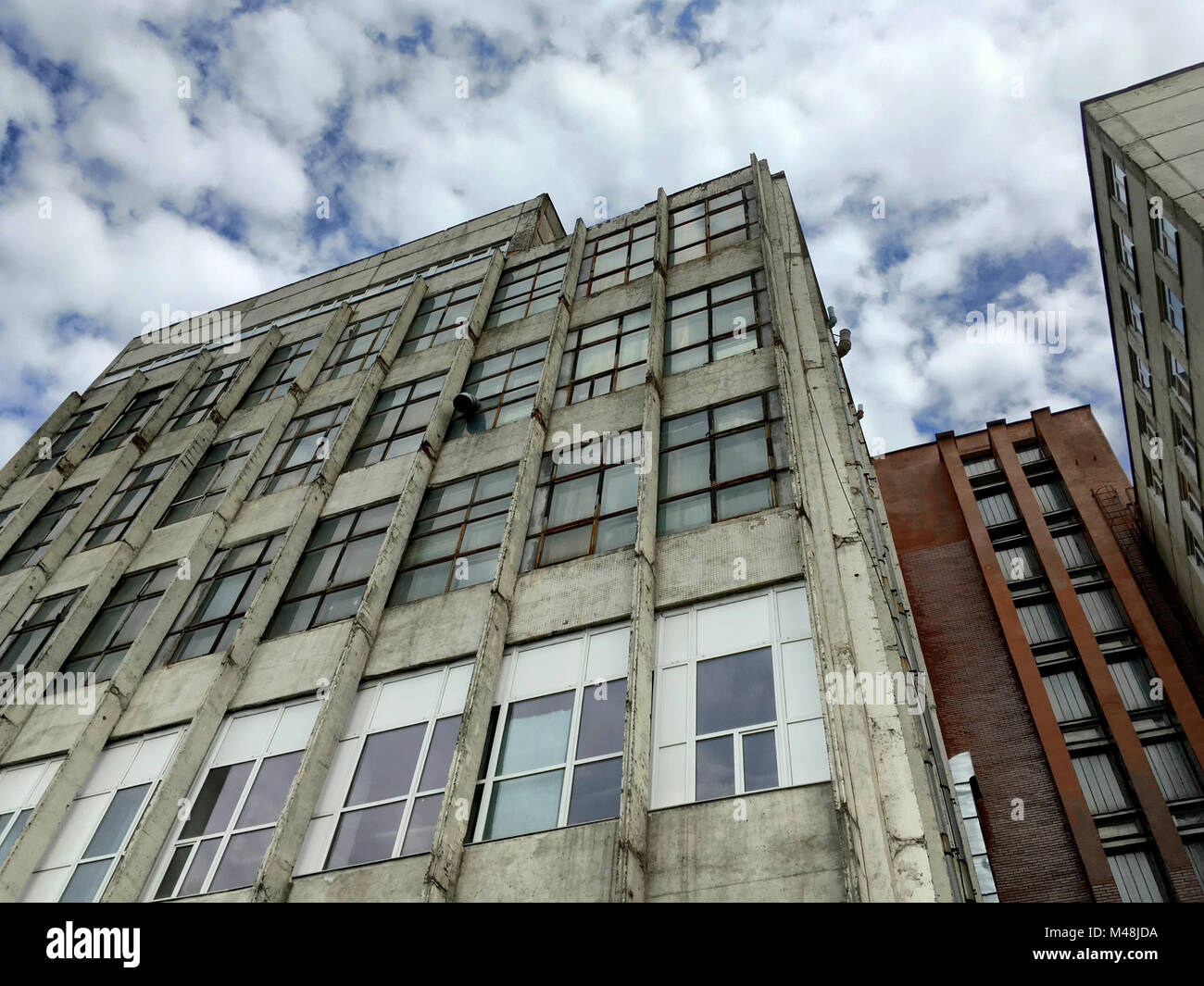 abandoned industrial building under dramatic sky Stock Photo