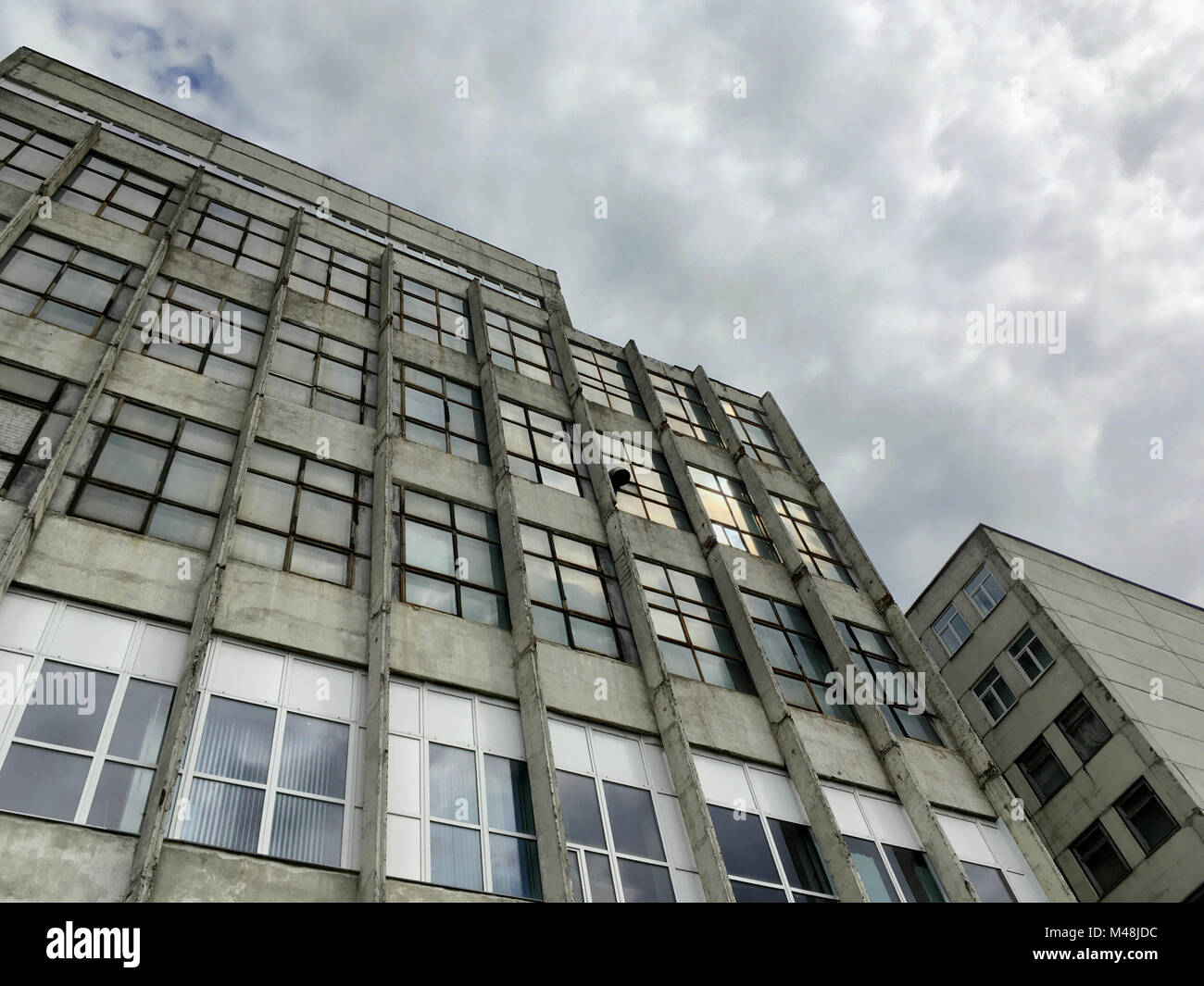 abandoned industrial building under dramatic sky Stock Photo