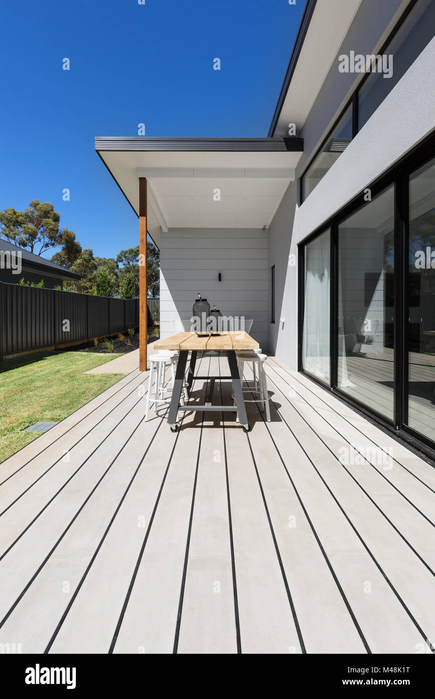 Large outdoor decking and high entertaining  table in a new home Stock Photo