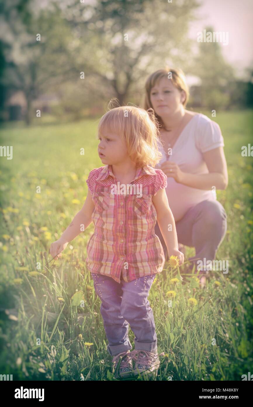 Cute little girl with the His pregnant mother Stock Photo