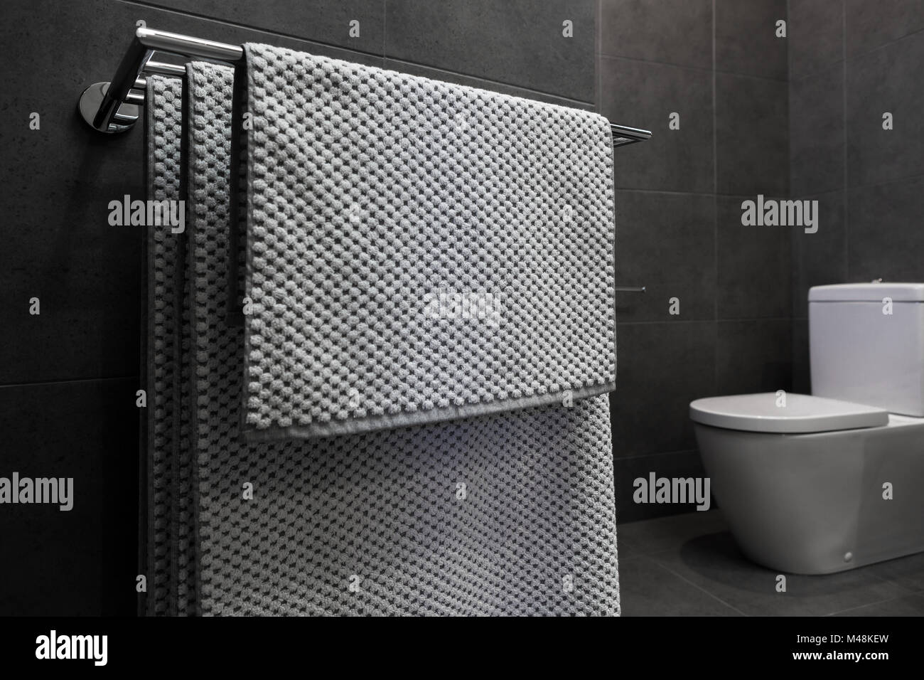 Close up of luxury bathroom towels in a monochrome ensuite Stock Photo