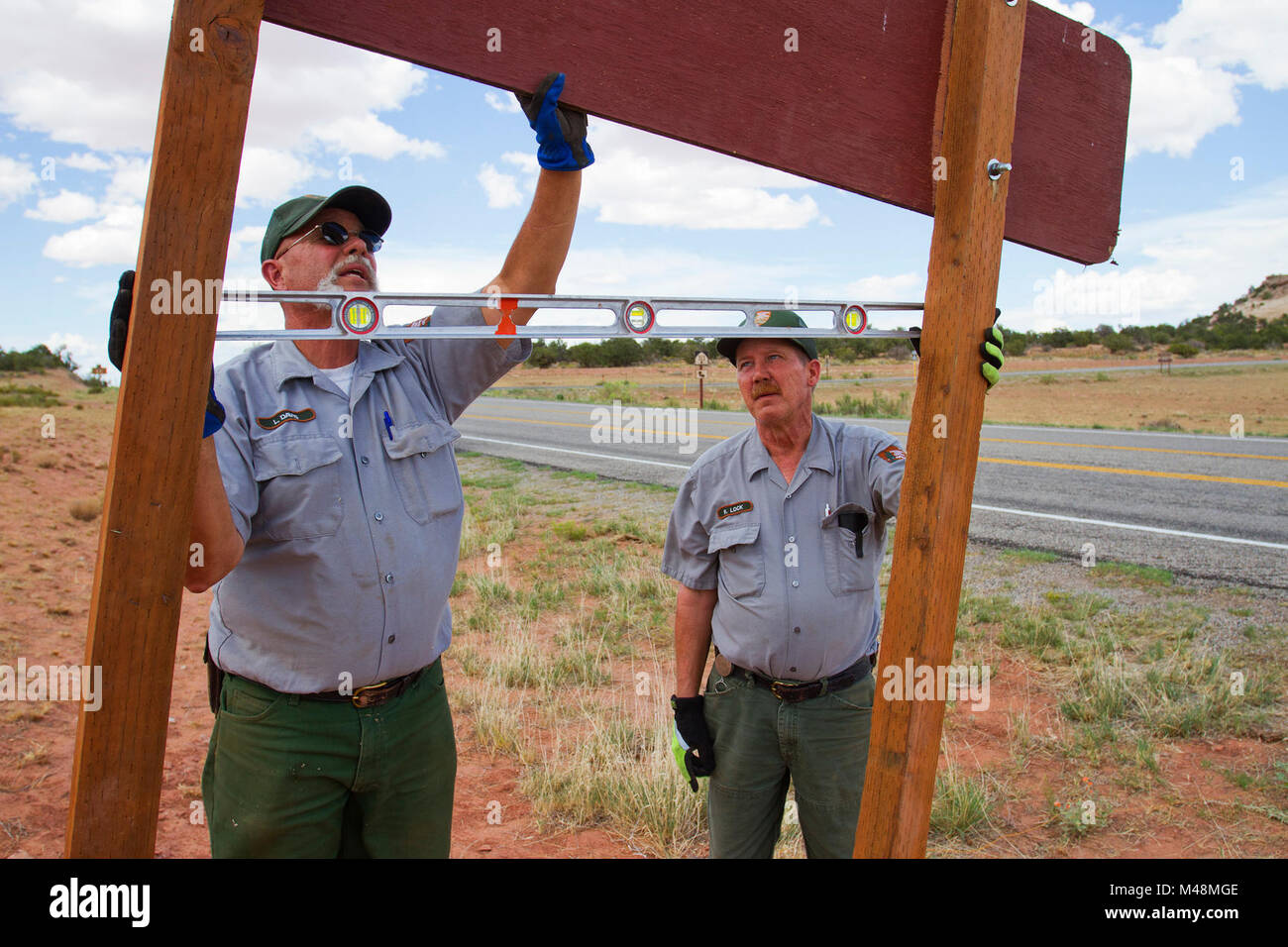 Larry Davis and  Roger Lock installing a new sign. Stock Photo