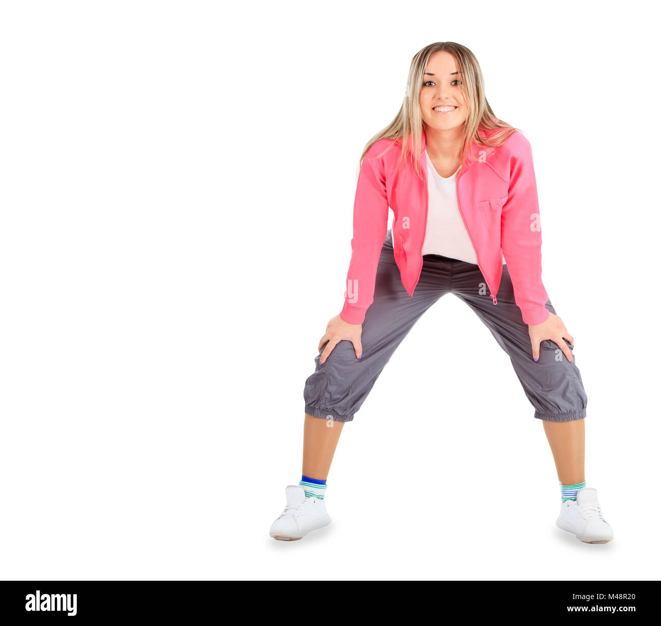 Young smiling woman in sportwear isolated over white Stock Photo