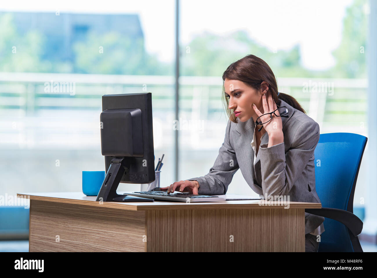 Young businesswoman tired after long working day Stock Photo - Alamy