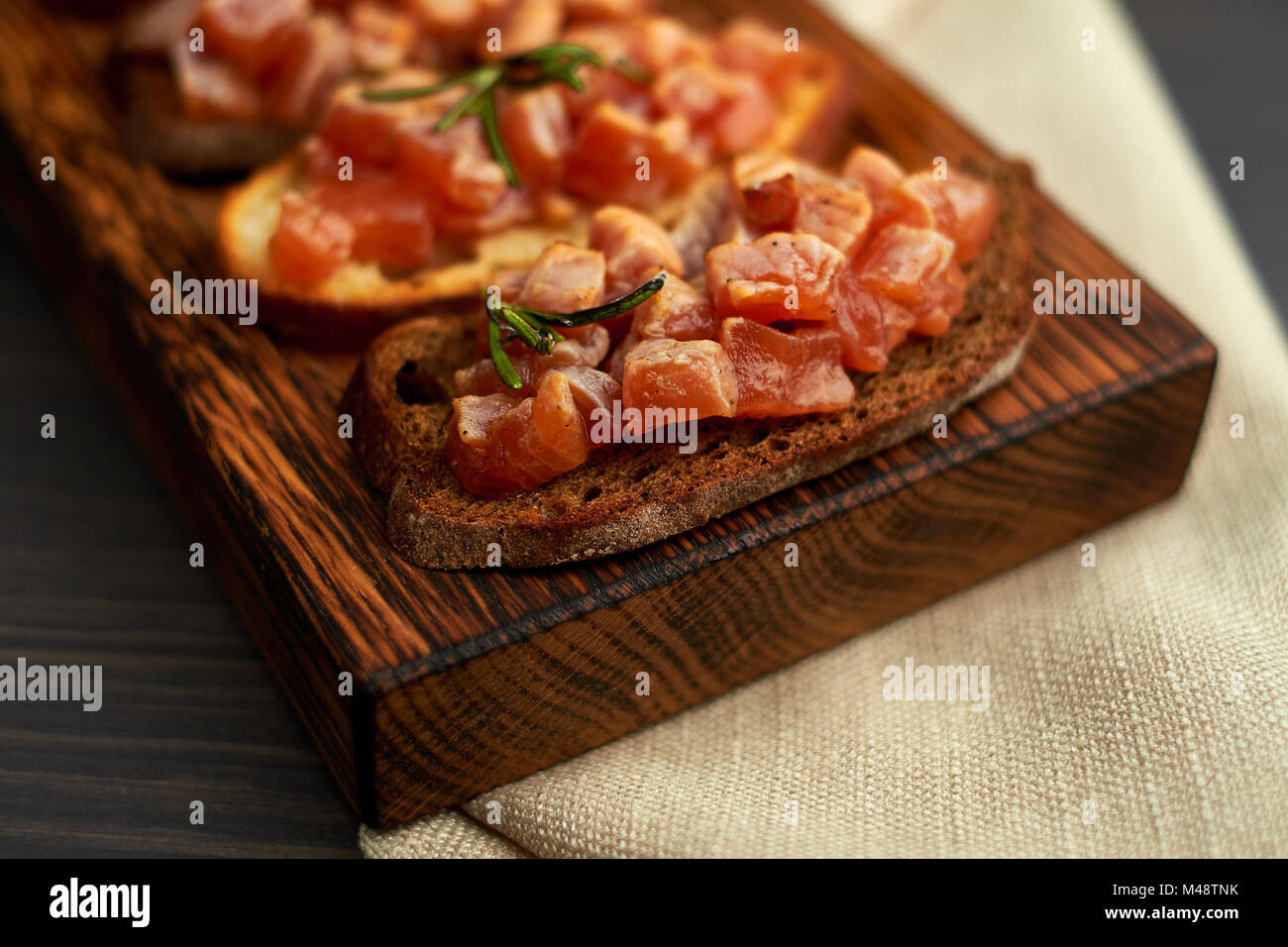 bruschetta with delicious fish on a cream cushion with capers and olive