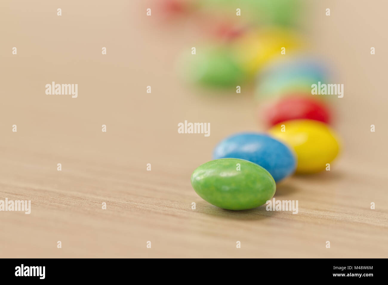 Candy scattered on the table Stock Photo - Alamy