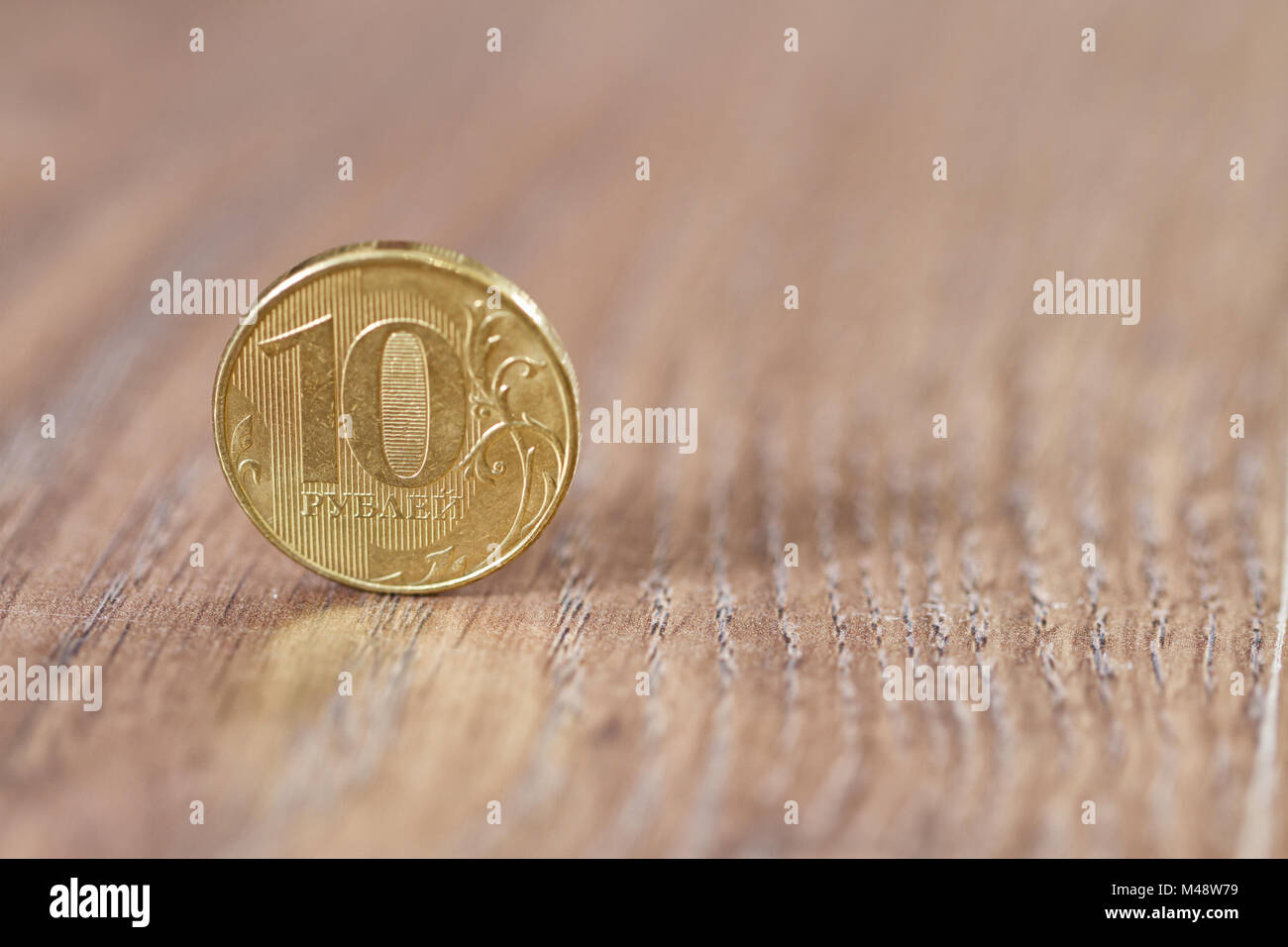 Gold coin ten robles worth on the wooden floor Stock Photo