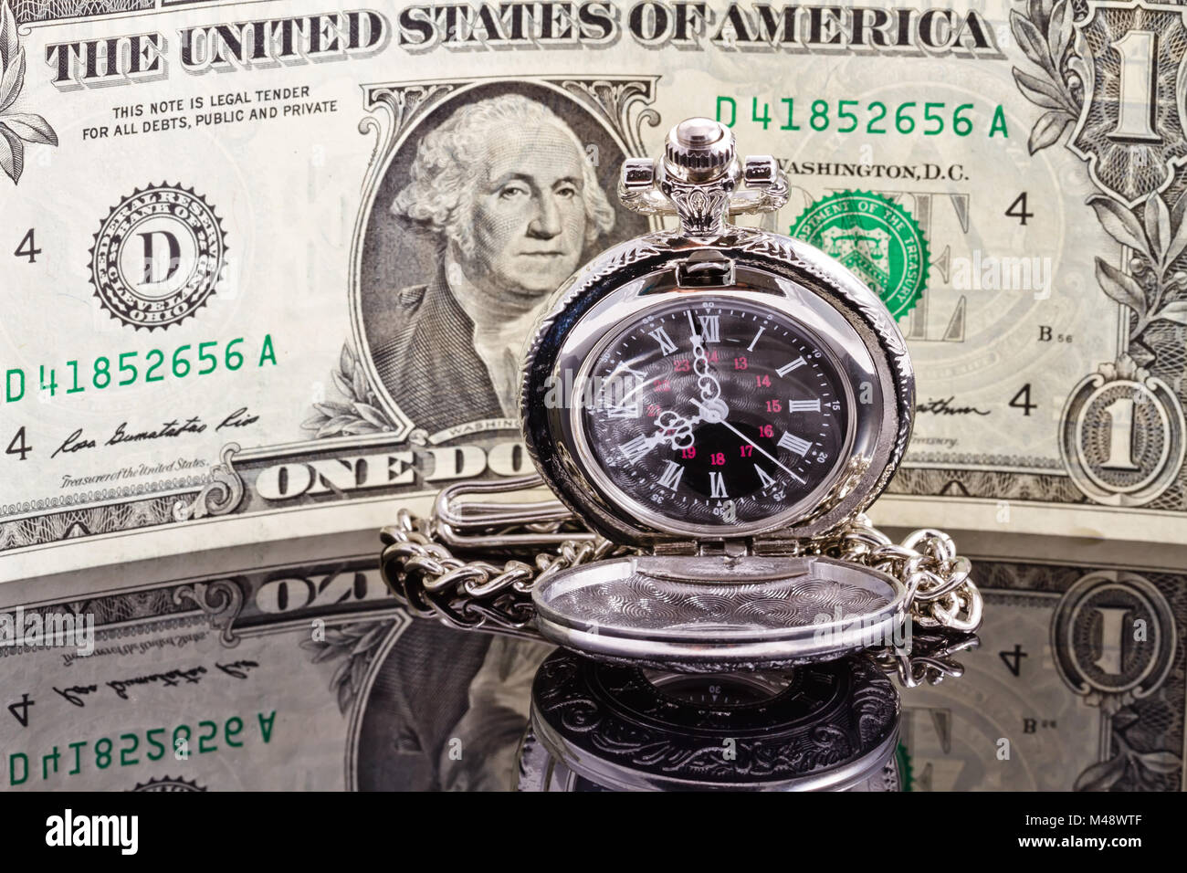 Pocket watch where the arrows show 8-00 and the dollar Stock Photo