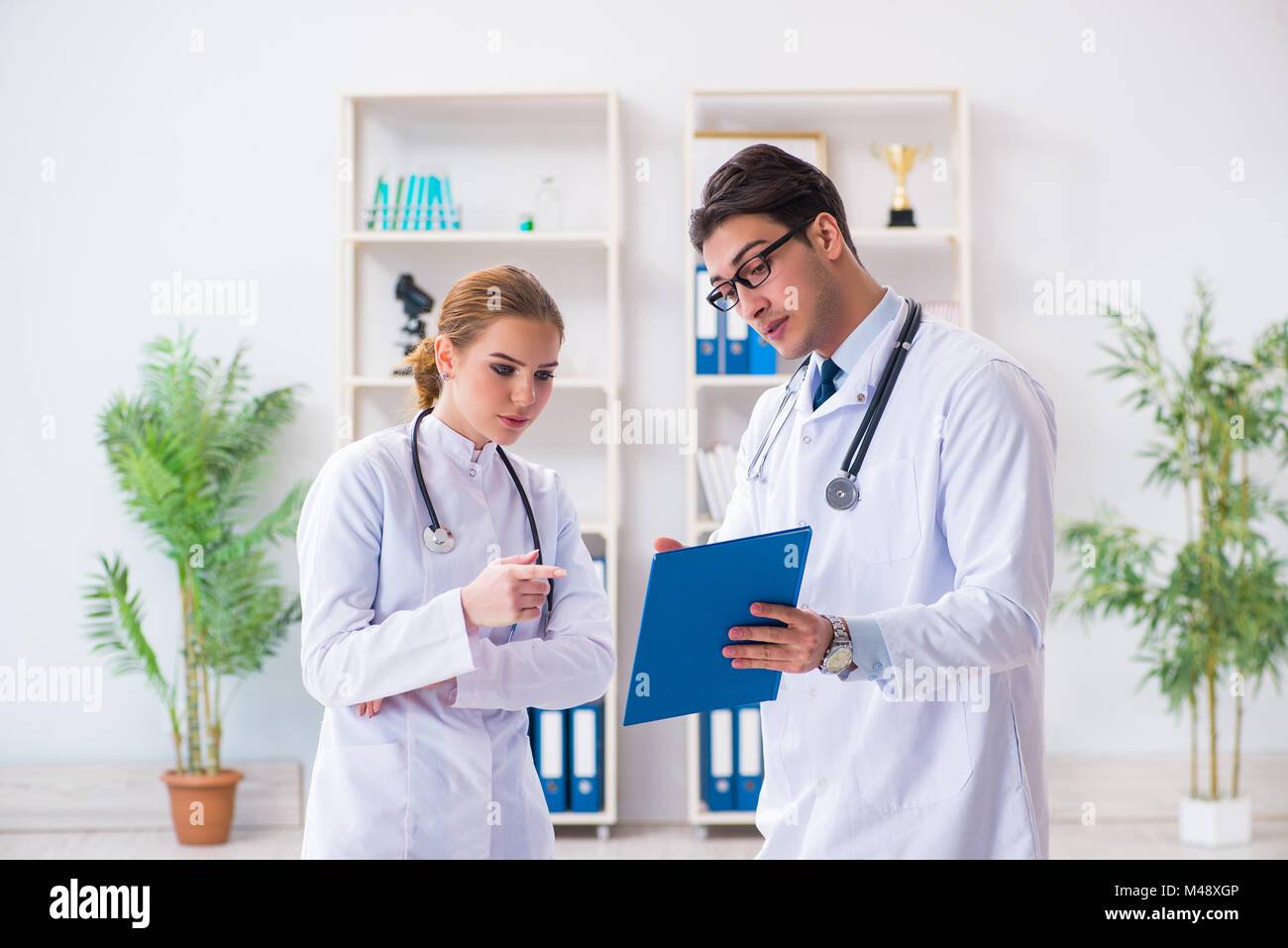 Male and female doctor having discussion in hospital Stock Photo - Alamy