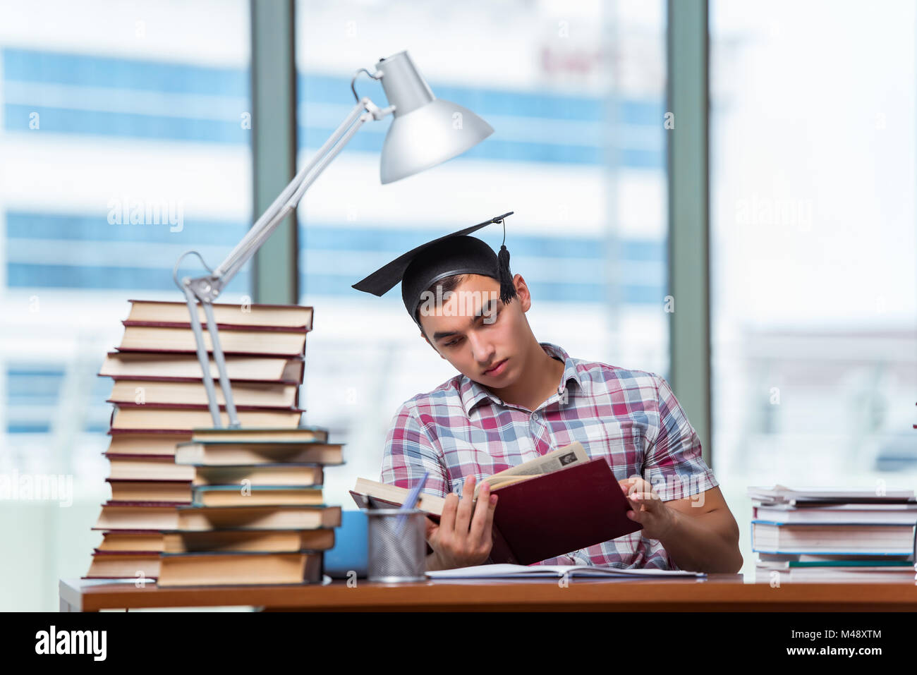 Young man preparing for graduation exams in college Stock Photo - Alamy
