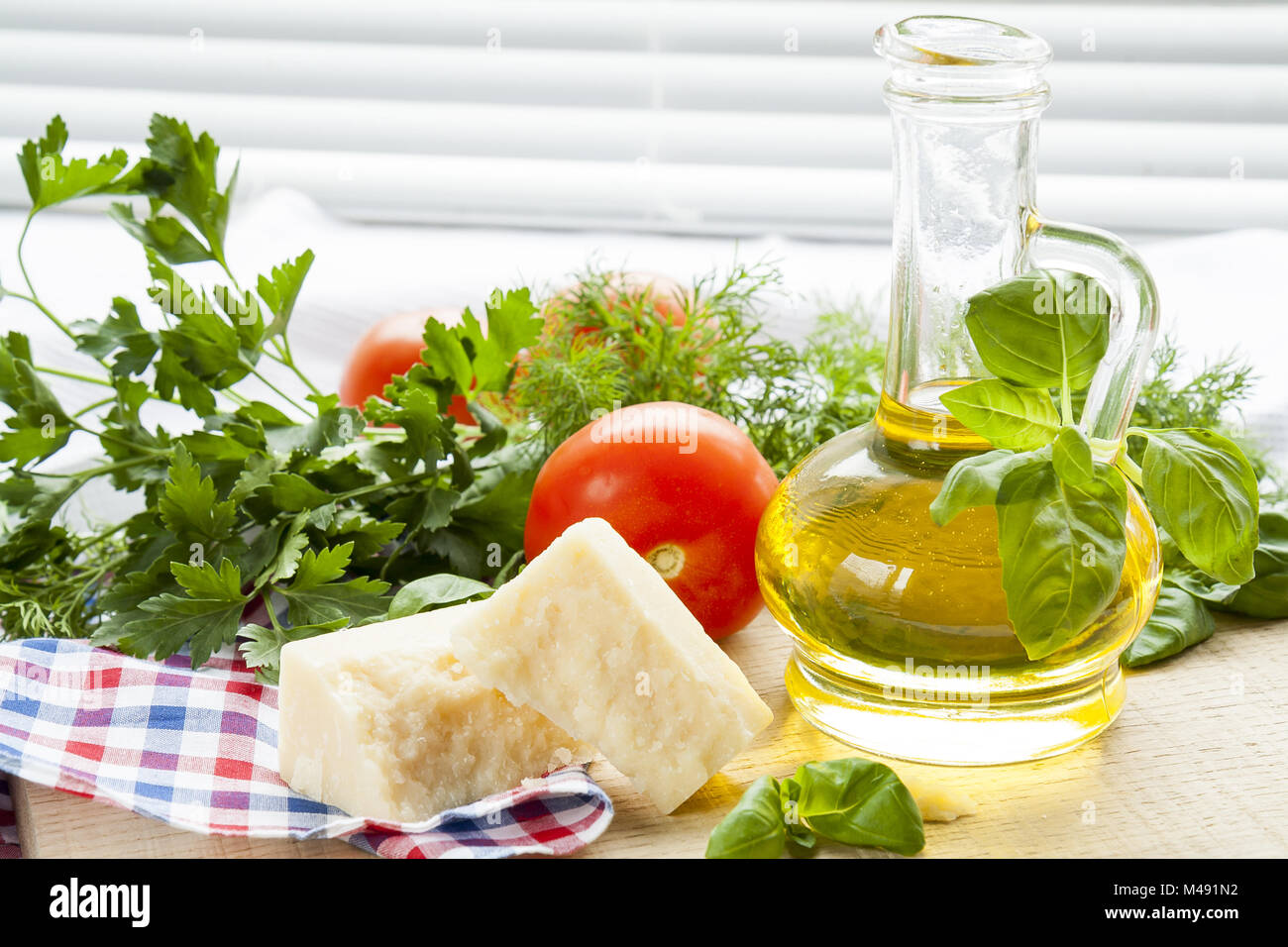 Parmigiano cheese, olive oil herbs and tomatoes Stock Photo Alamy