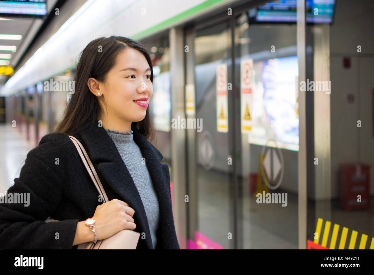 Girl waiting for the metro at a subway station Stock Photo Alamy