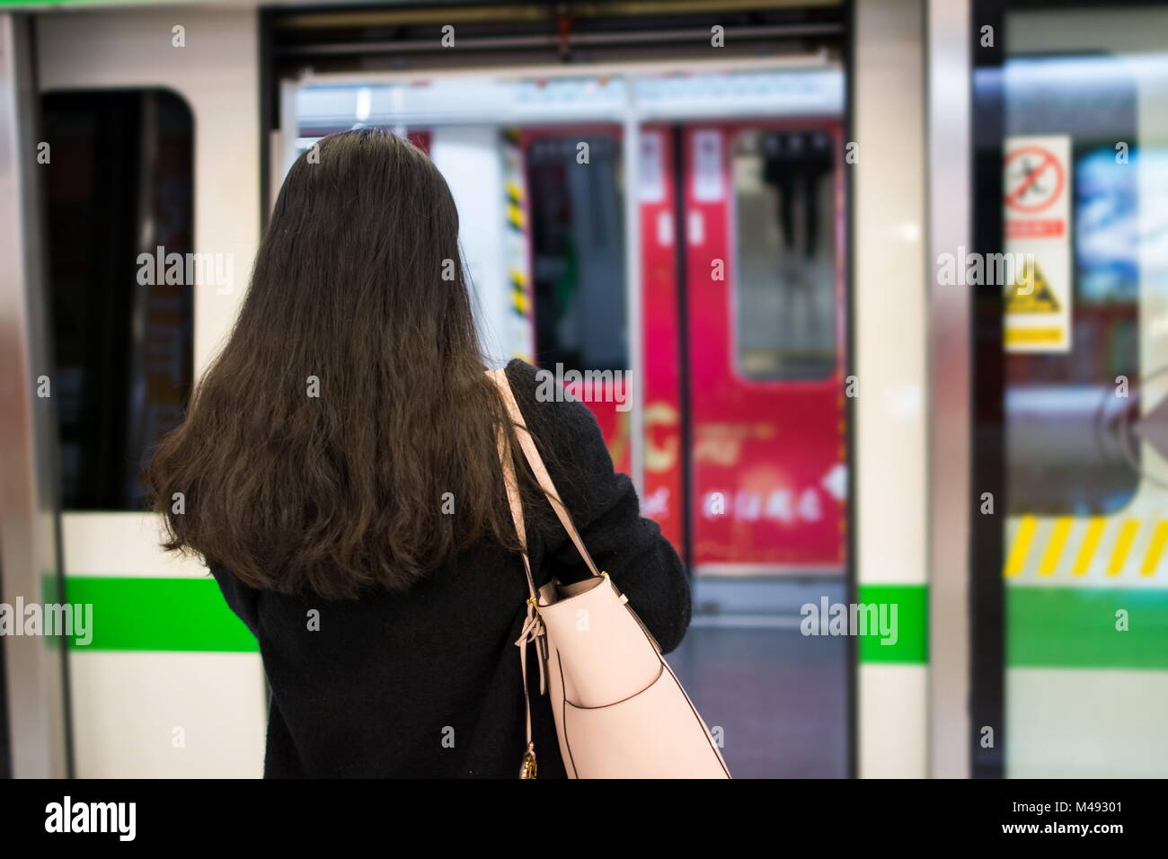 Girl entering metro at a subway station Stock Photo
