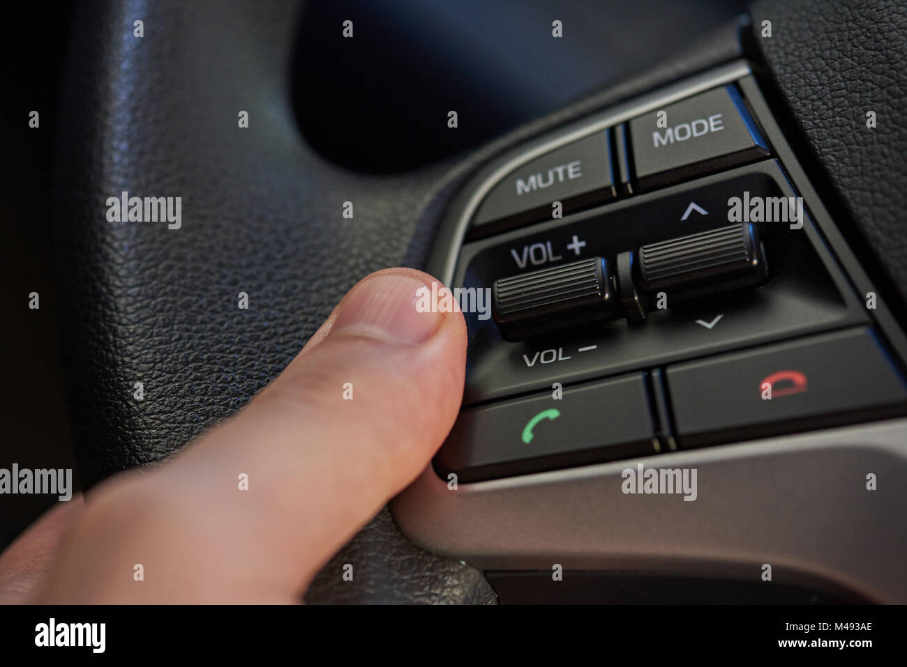 Steering wheel with control buttons close-up. Car stereo system control Stock Photo