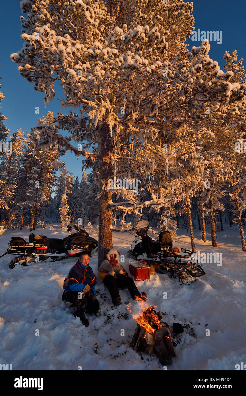 People on snowmobile trip into the wilderness, Jukkasjarvi, Lapland, Laponia, Norrbotten county, Sweden Model released. Stock Photo