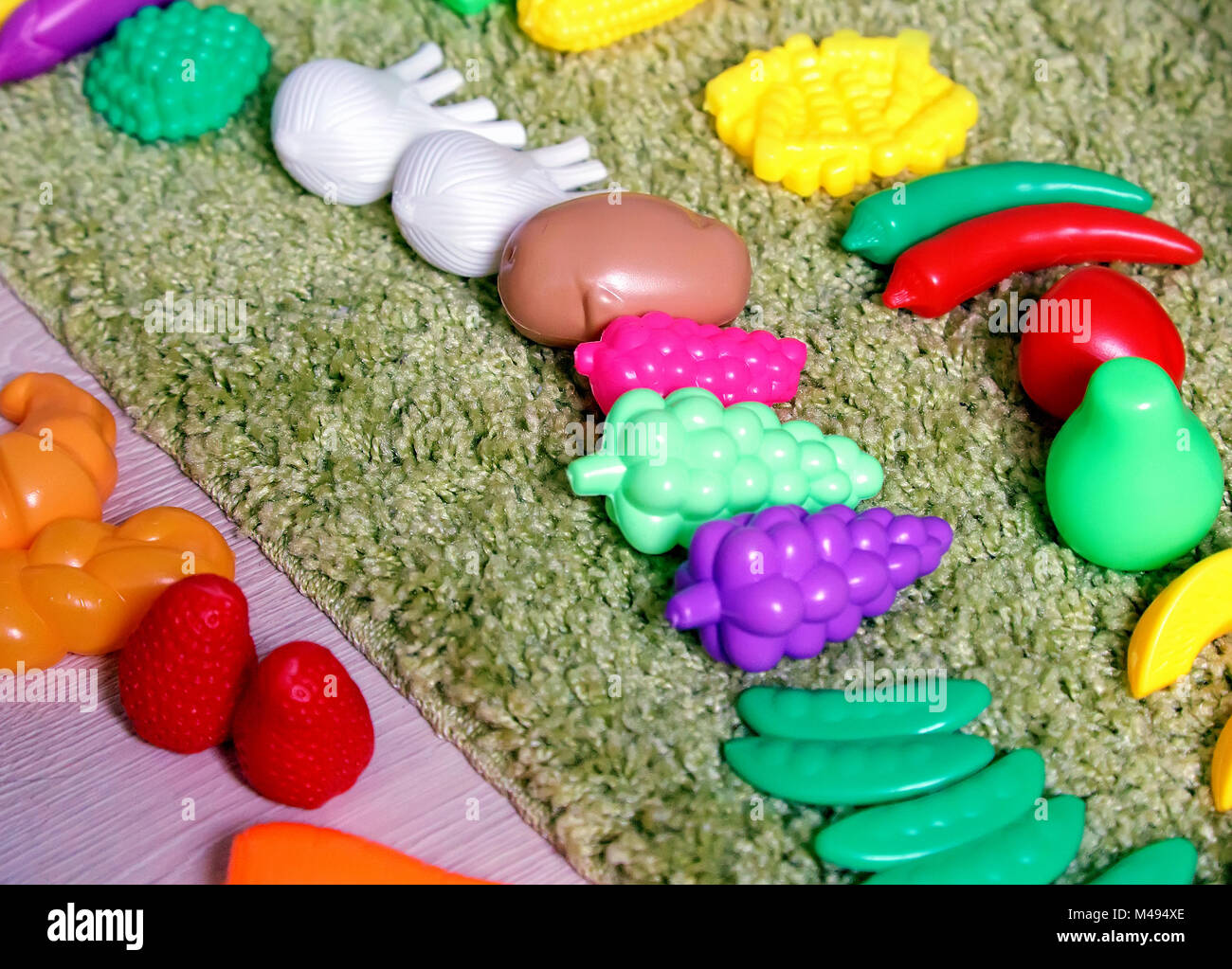 Plastic children's toys in the form of vegetables and fruits. Stock Photo