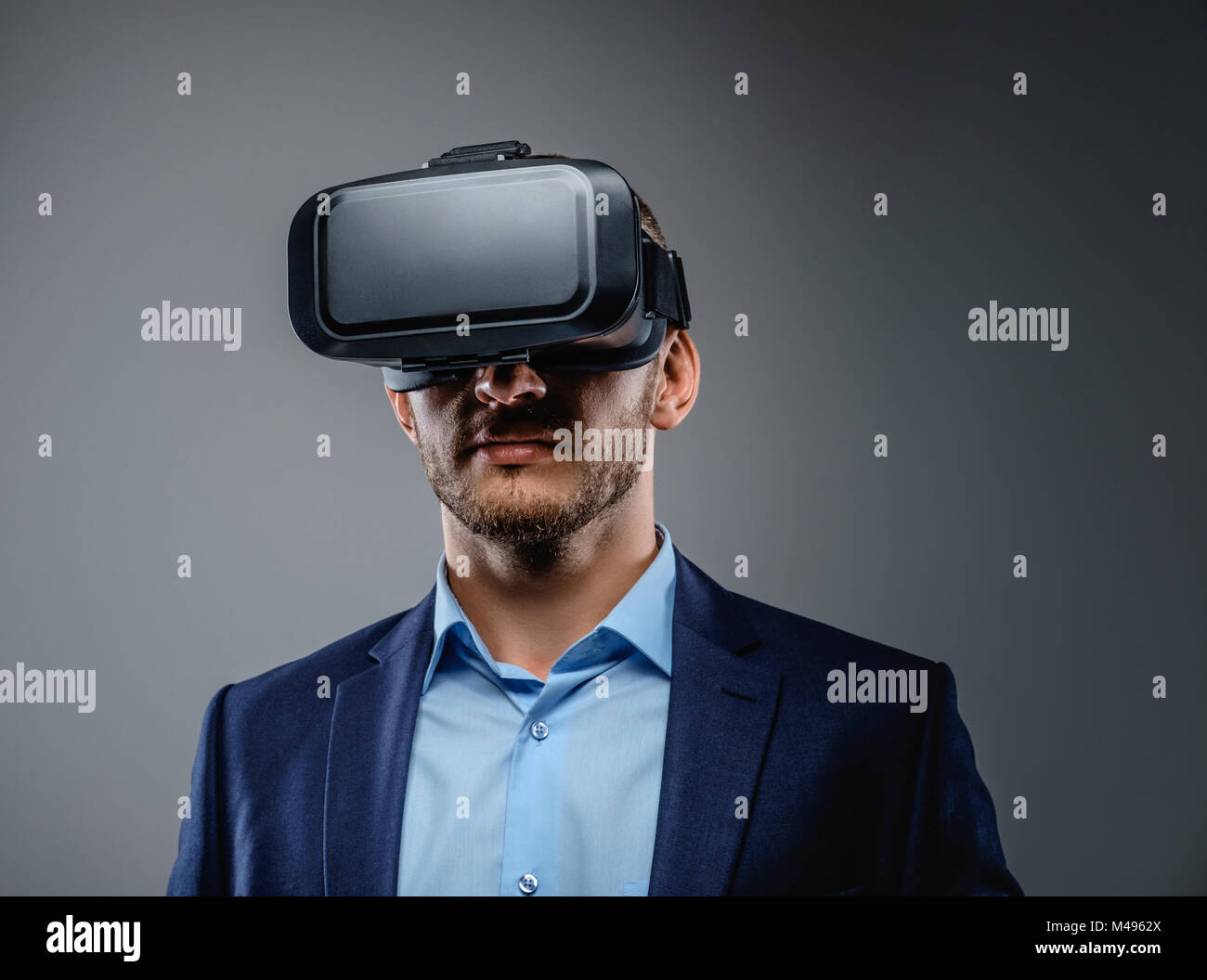 Male in a suit with virtual reality glasses on his head Stock Photo - Alamy