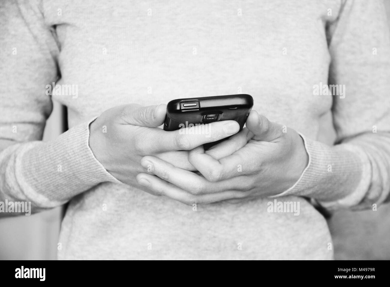 Hands holding smartphone toned in vintage style Stock Photo