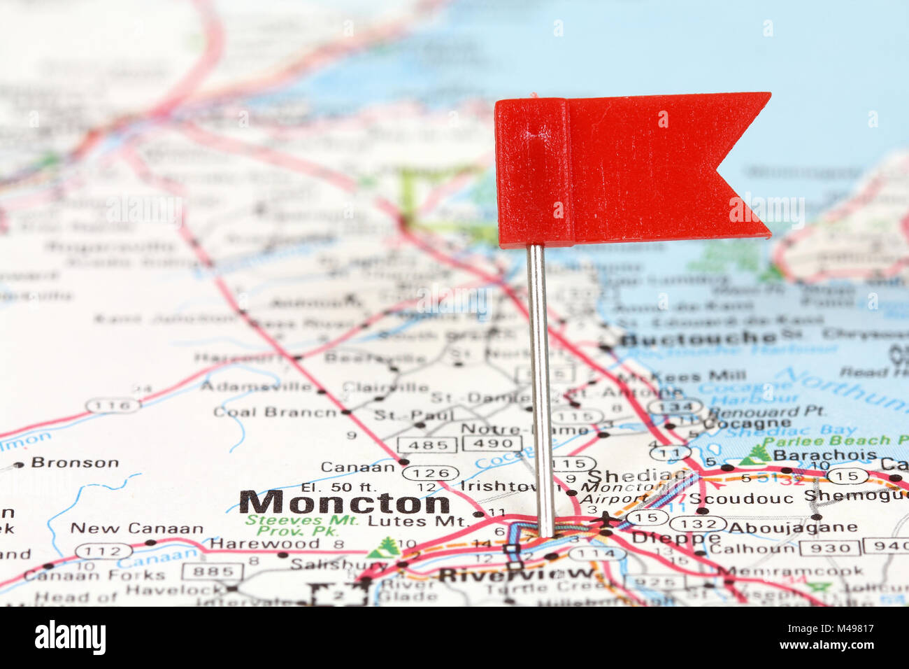 Moncton in New Brunswick, Canada. Red flag pin on an old map showing travel destination. Stock Photo