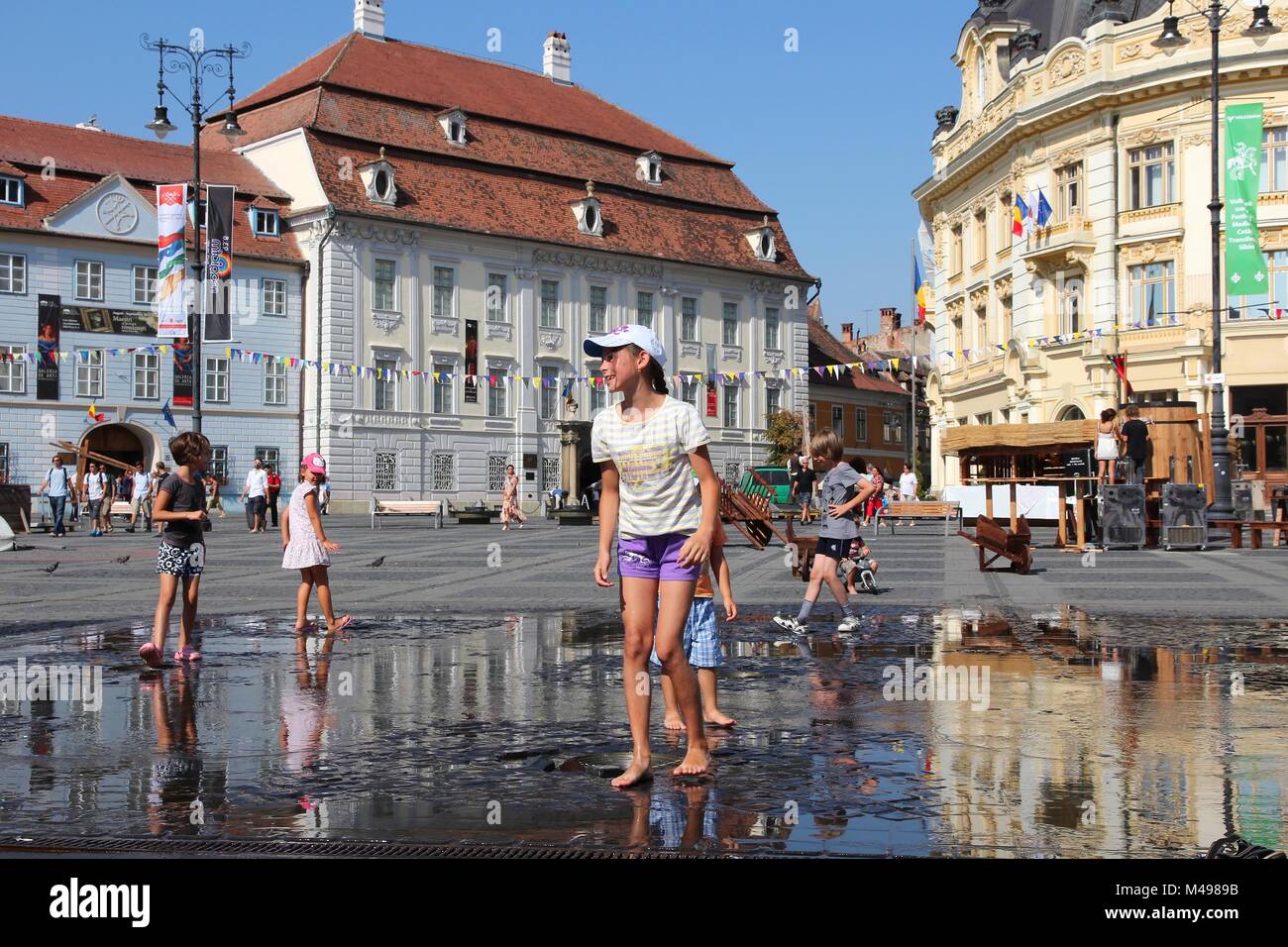 SIBIU, ROMANIA - AUGUST 24: People visit main square on August 24, 2012 in Sibiu, Romania. Sibiu's tourism is growing with 284,513 museum visitors in  Stock Photo