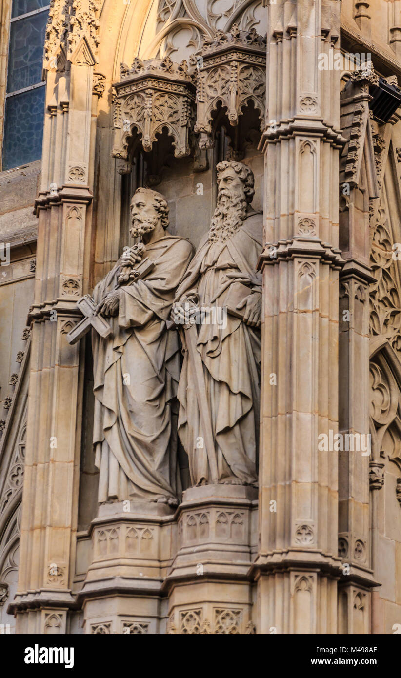 Ancient Statues of Two Priests on Church Stock Photo